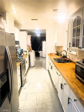 a kitchen with stainless steel appliances a sink stove and cabinets