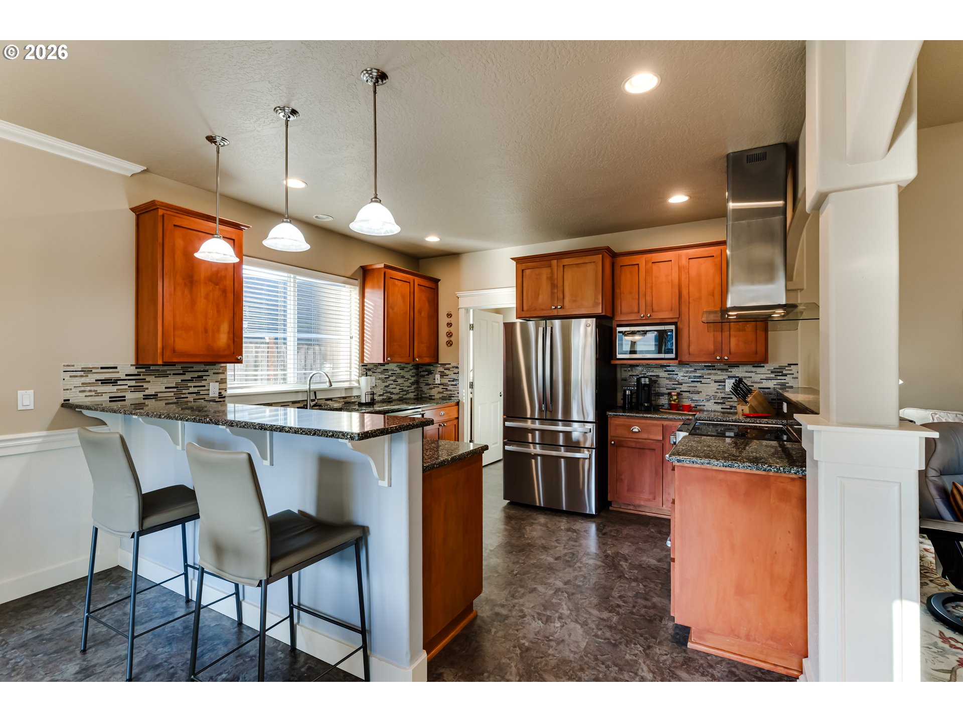 90 Daniel Drive Eugene, OR 97404 - Photo 14 of 48 a kitchen with refrigerator a sink a stove and chairs