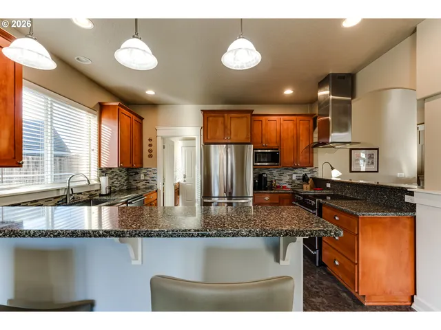 a kitchen with stainless steel appliances granite countertop counter space a sink and a granite counter tops