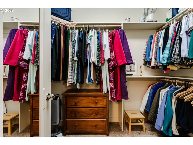 a view of walk in closet with clothes