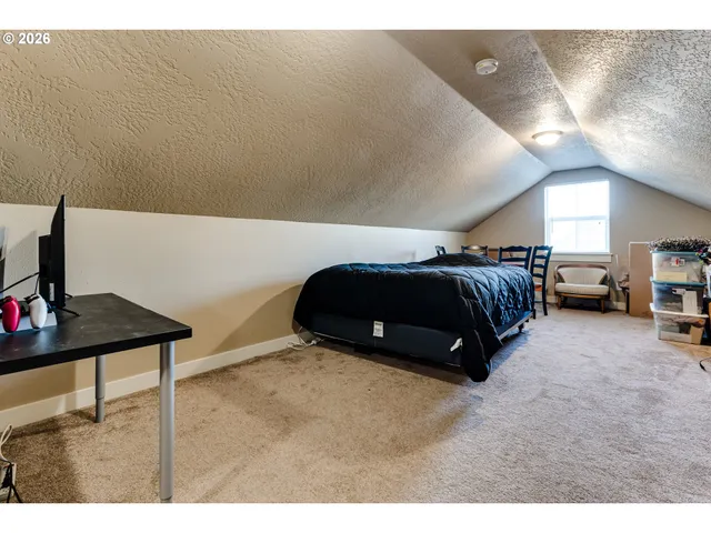 a spacious bedroom with a bed and a desk