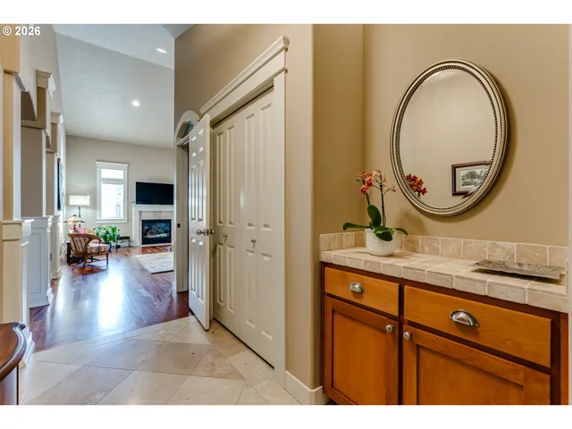 a hallway with a sink and a mirror