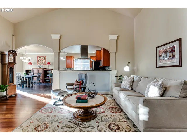 a living room with furniture and a chandelier