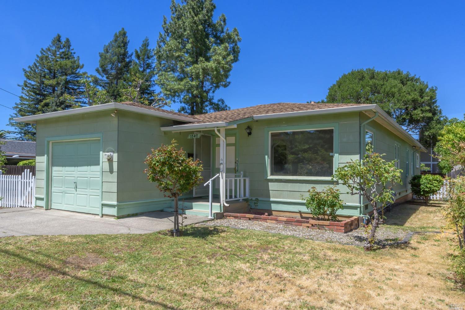 a house that has a tree in front of it