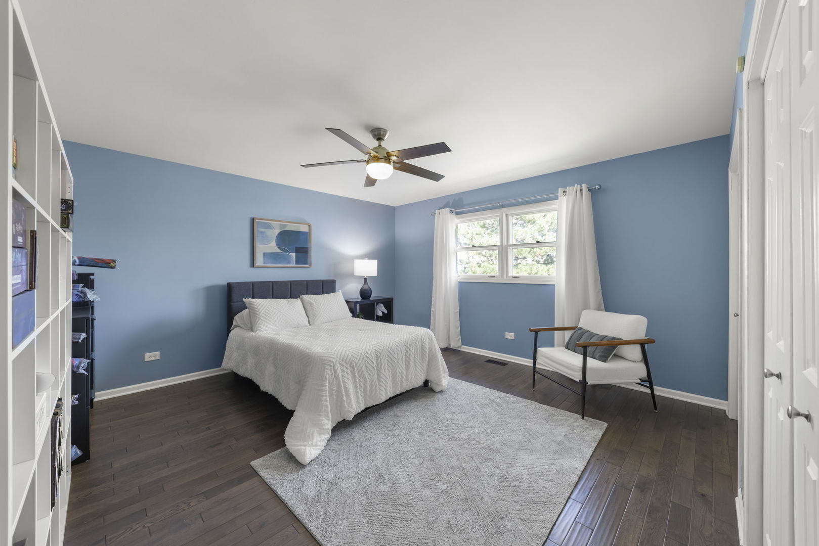 8937 Tara Hill Road Darien, IL 60561 - Photo 13 of 24 a spacious bedroom that has a bed and a chair in it