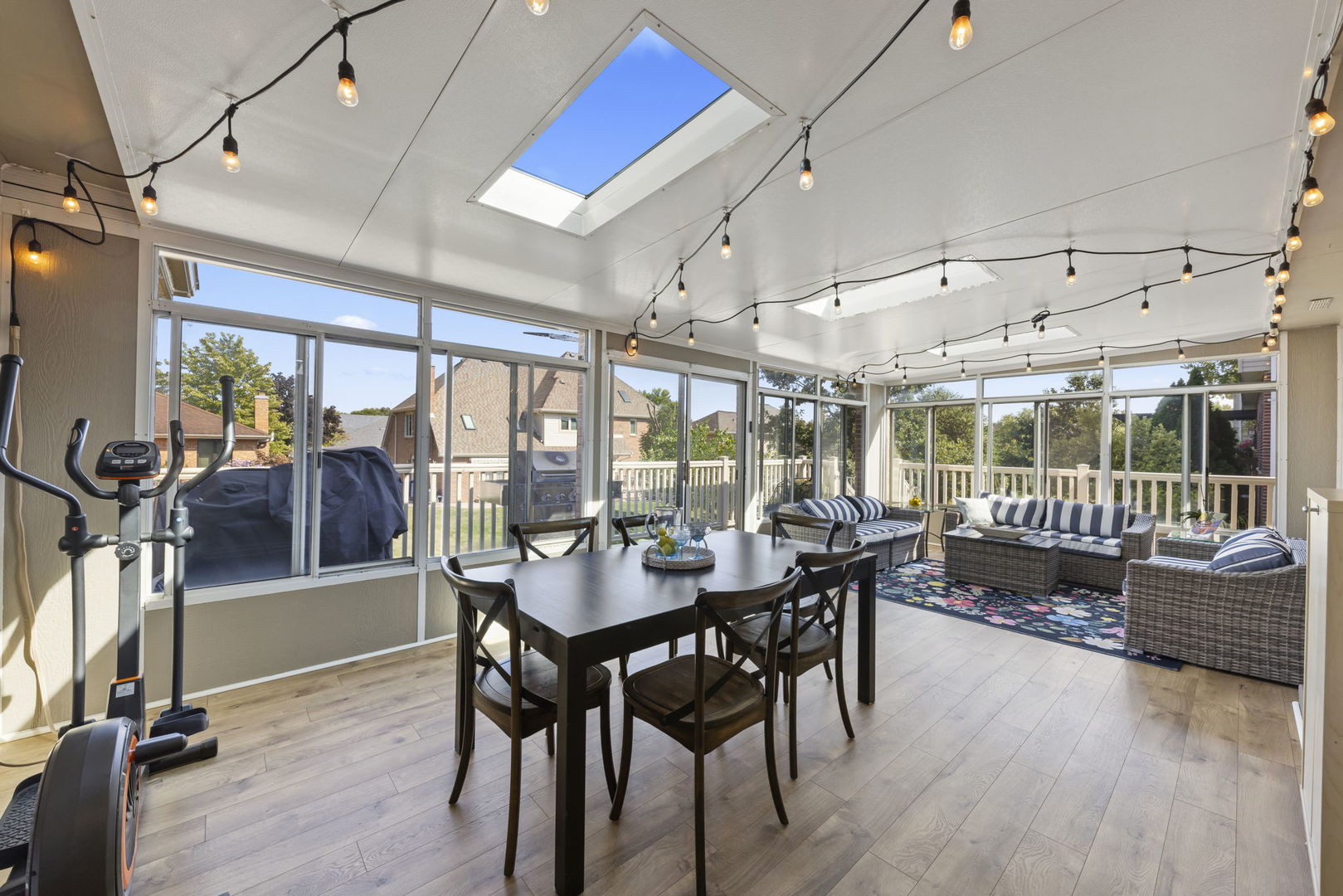 8937 Tara Hill Road Darien, IL 60561 - Photo 6 of 24 a dining room with wooden floor glass table and chairs