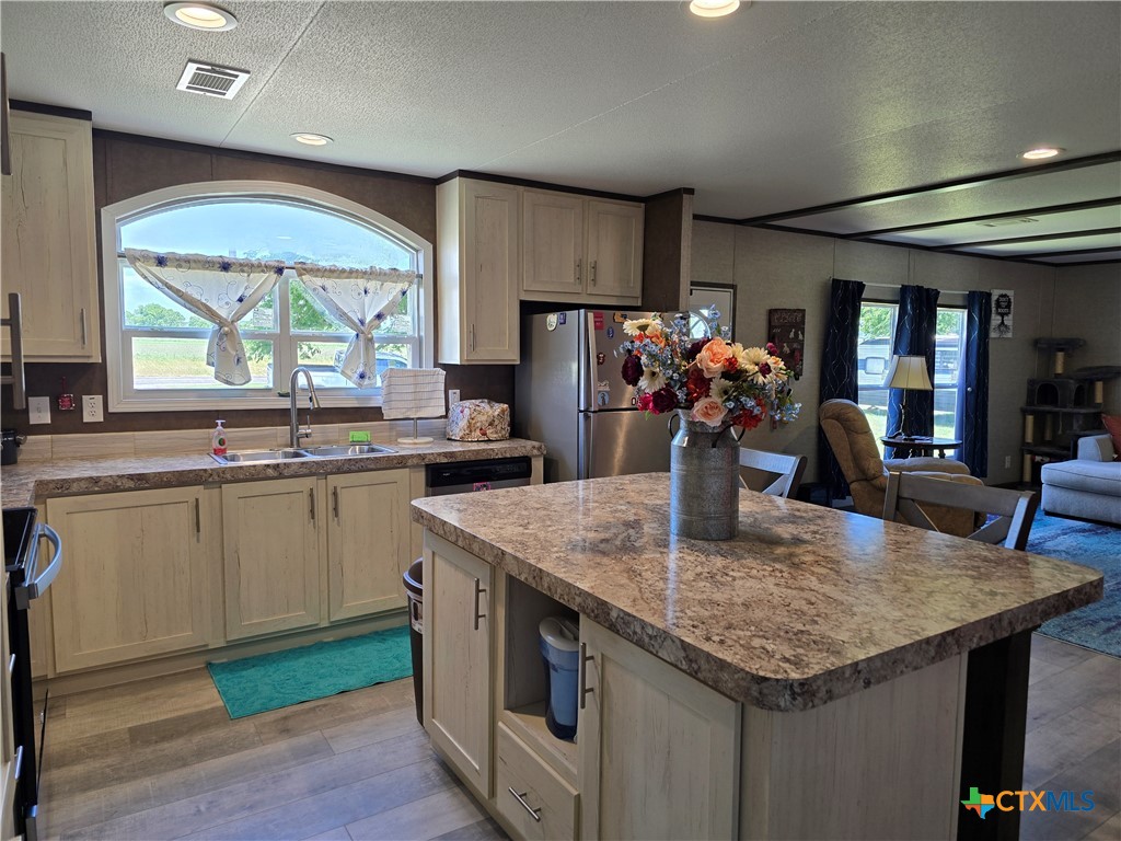 412 Coryell City Road Gatesville, TX 76528 - Photo 8 of 34 a kitchen with stainless steel appliances granite countertop stove top oven and cabinets