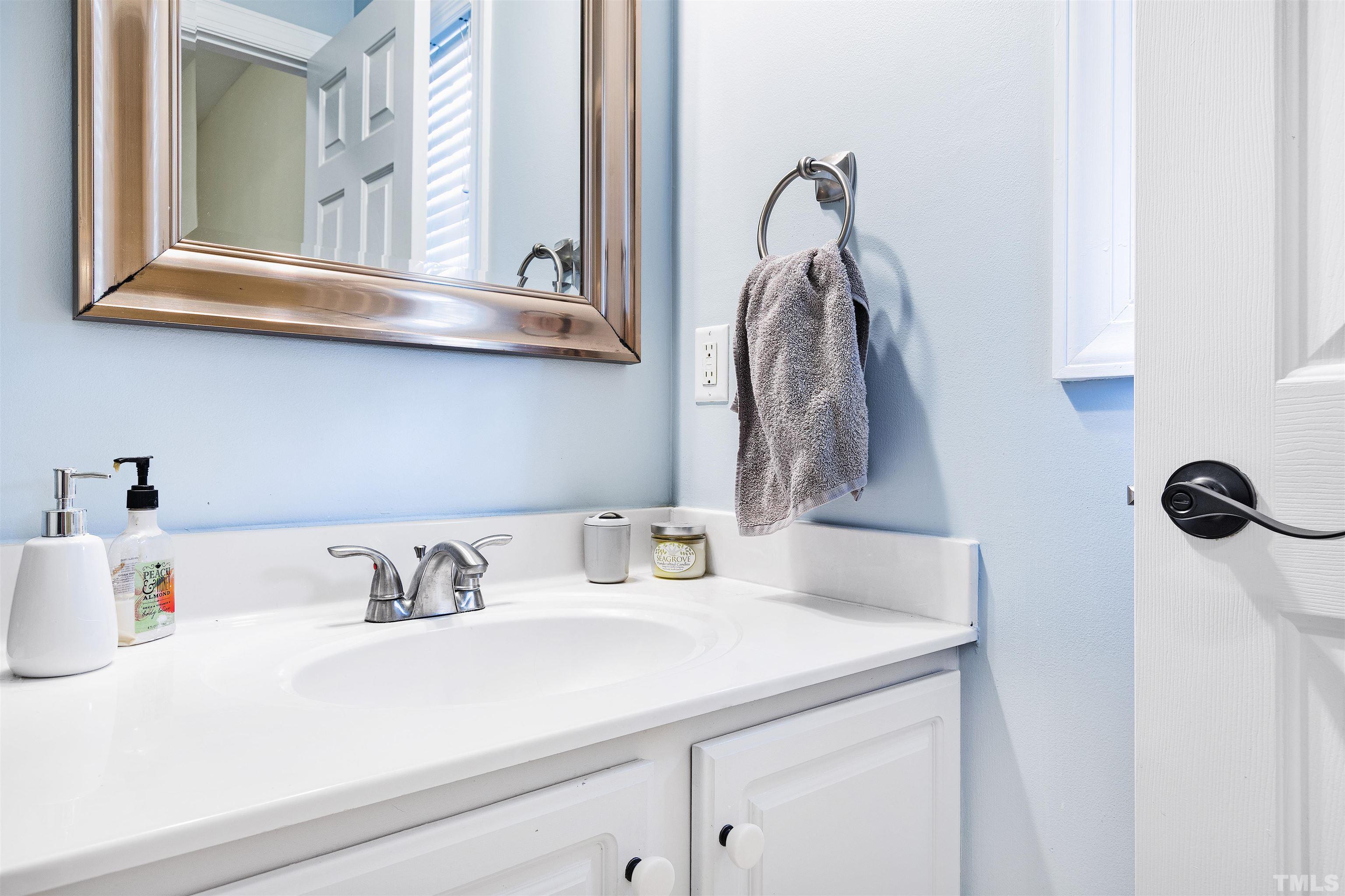 4928 Morning Edge Drive Raleigh, NC 27613 - Photo 11 of 25 a bathroom with a sink and a mirror