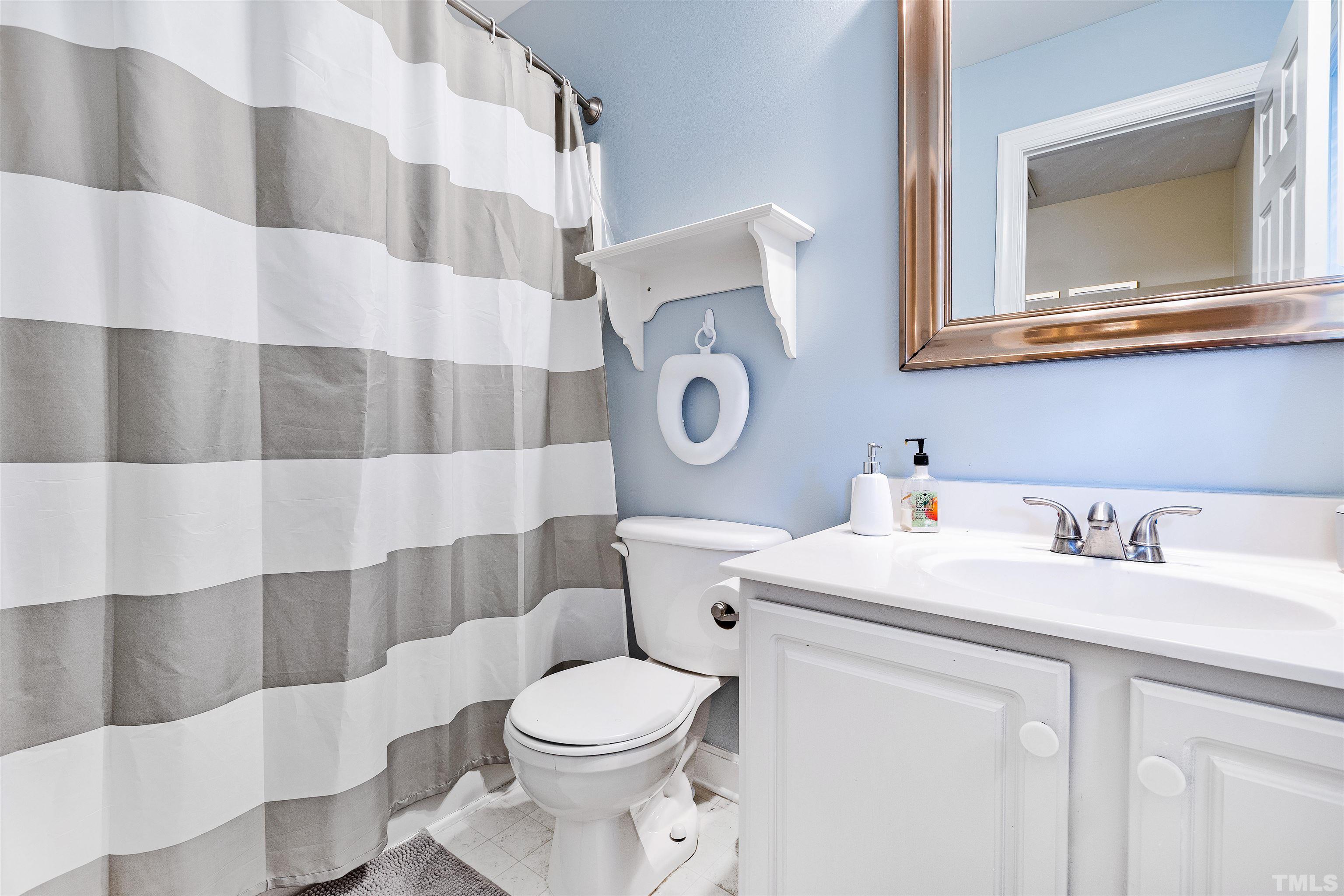 4928 Morning Edge Drive Raleigh, NC 27613 - Photo 12 of 25 a bathroom with a sink and a toilet