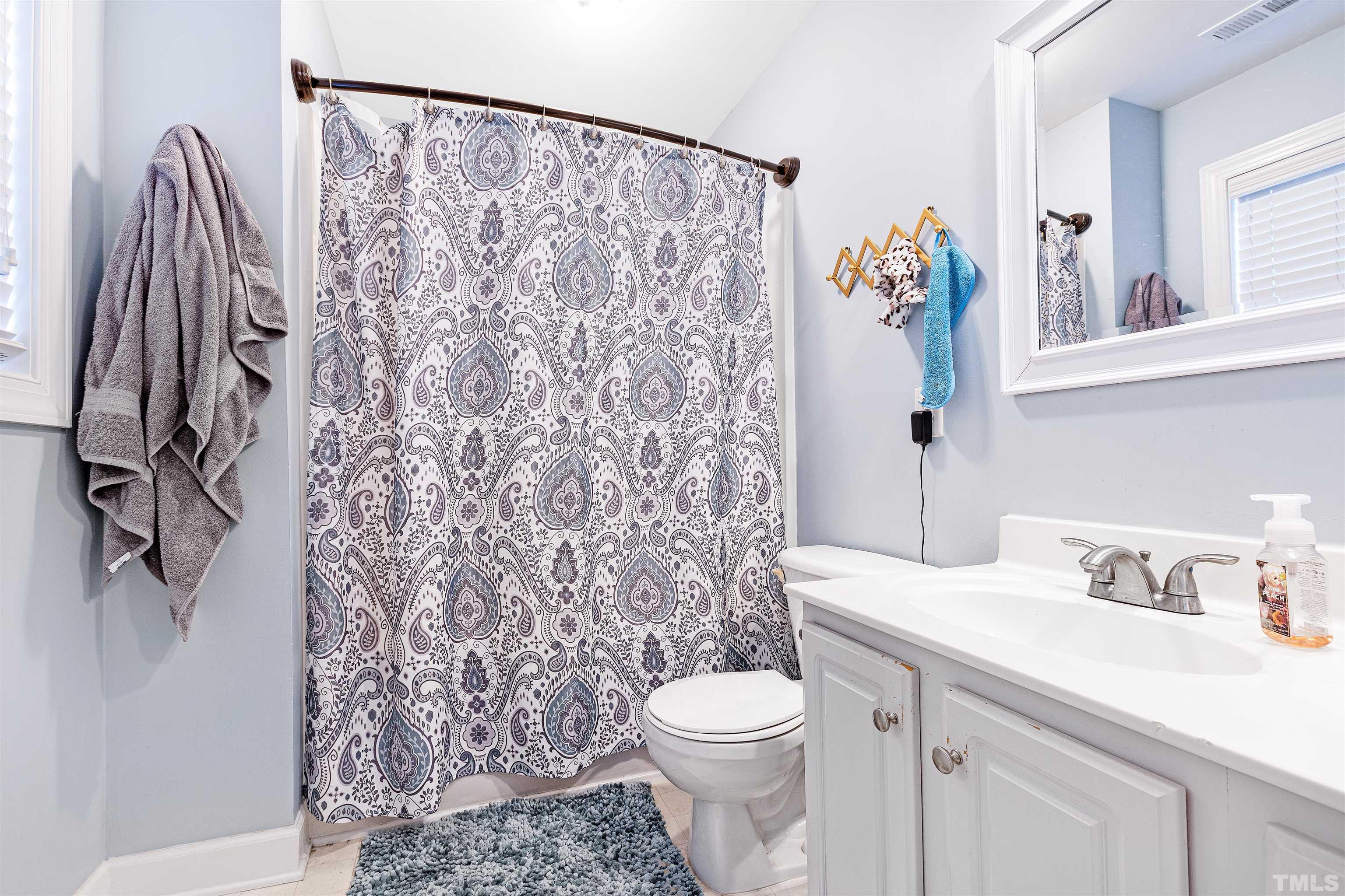 4928 Morning Edge Drive Raleigh, NC 27613 - Photo 14 of 25 a bathroom with a sink toilet and shower