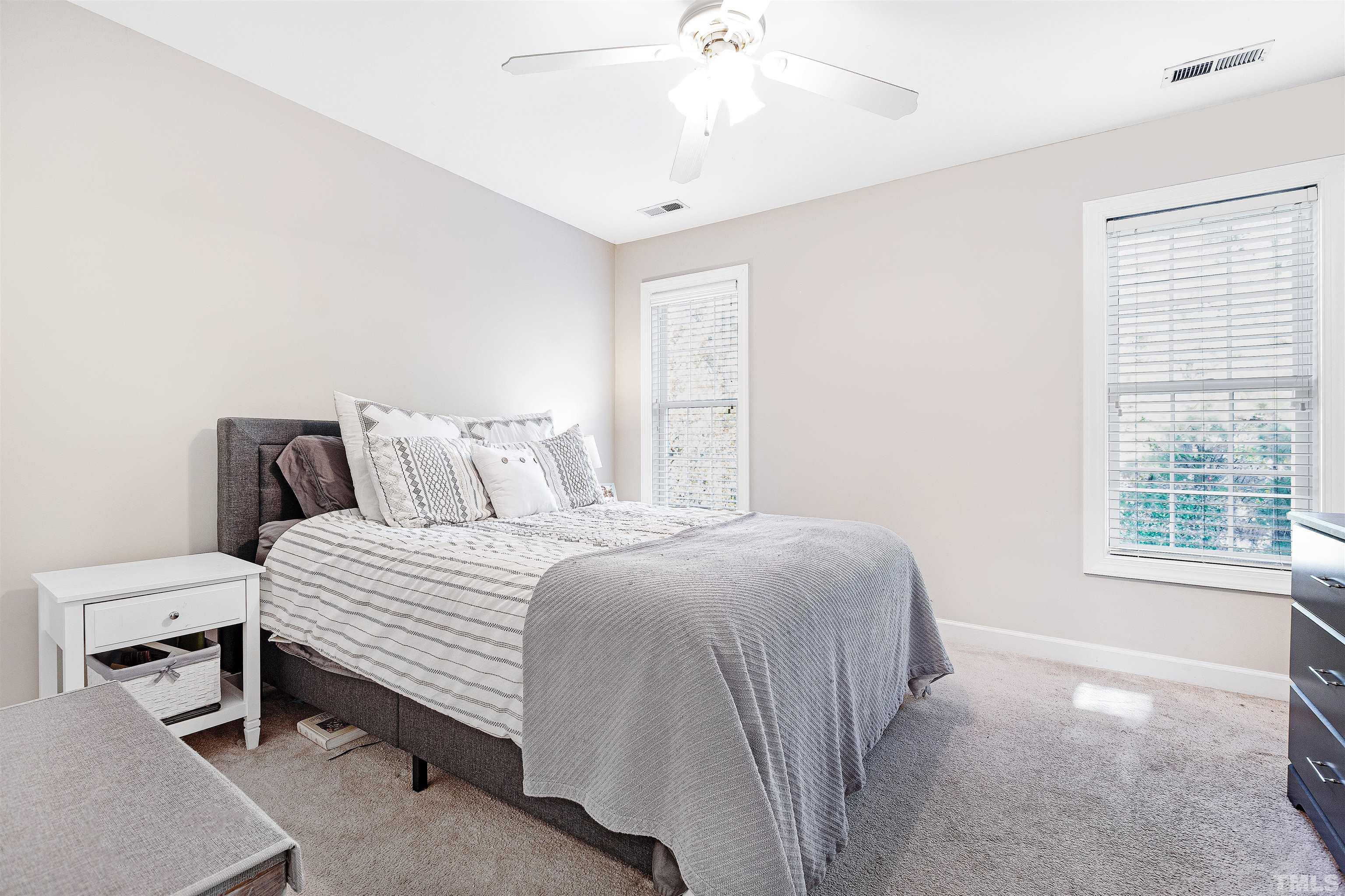4928 Morning Edge Drive Raleigh, NC 27613 - Photo 19 of 25 a bedroom with a bed table and window
