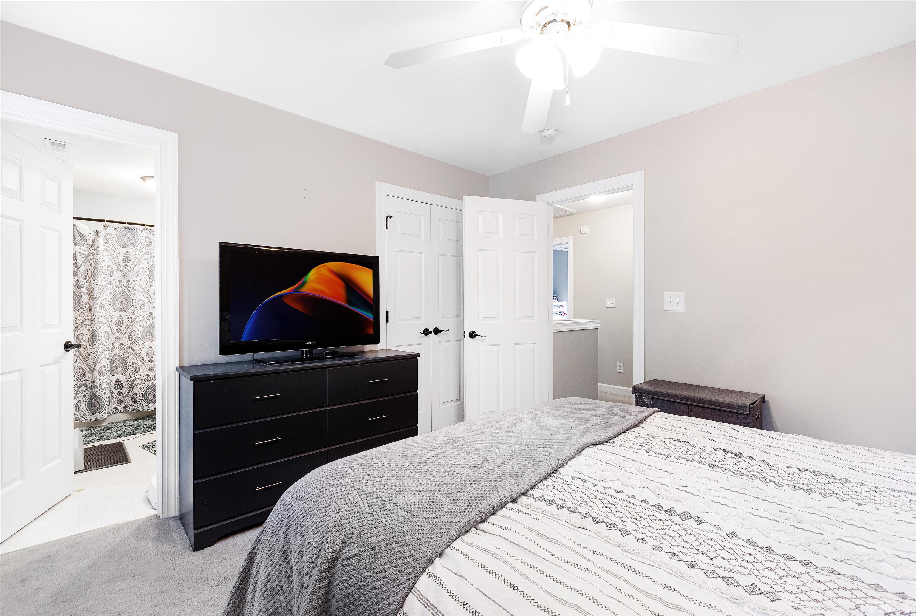 4928 Morning Edge Drive Raleigh, NC 27613 - Photo 20 of 25 a bedroom with a bed and a dresser