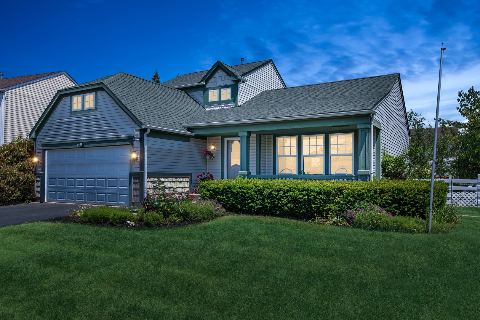 a front view of a house with a garden