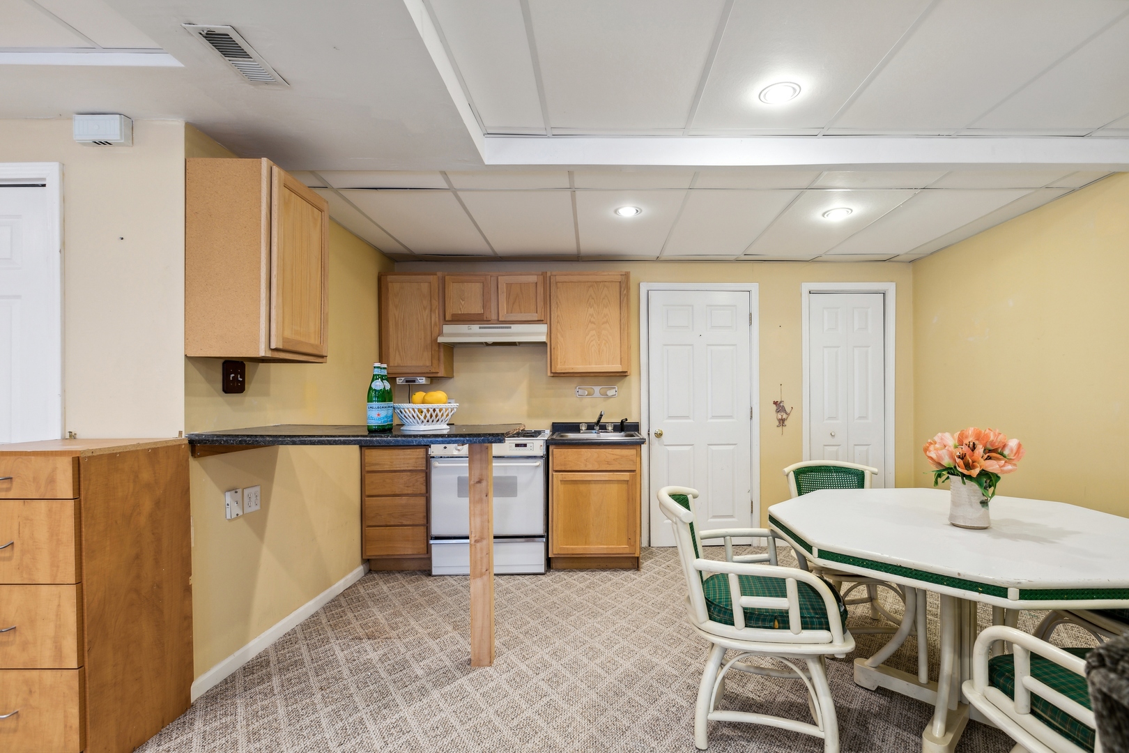 1039 Willow Bay Elgin, IL 60123 - Photo 20 of 30 a kitchen with stainless steel appliances granite countertop a stove a refrigerator a kitchen island and chairs