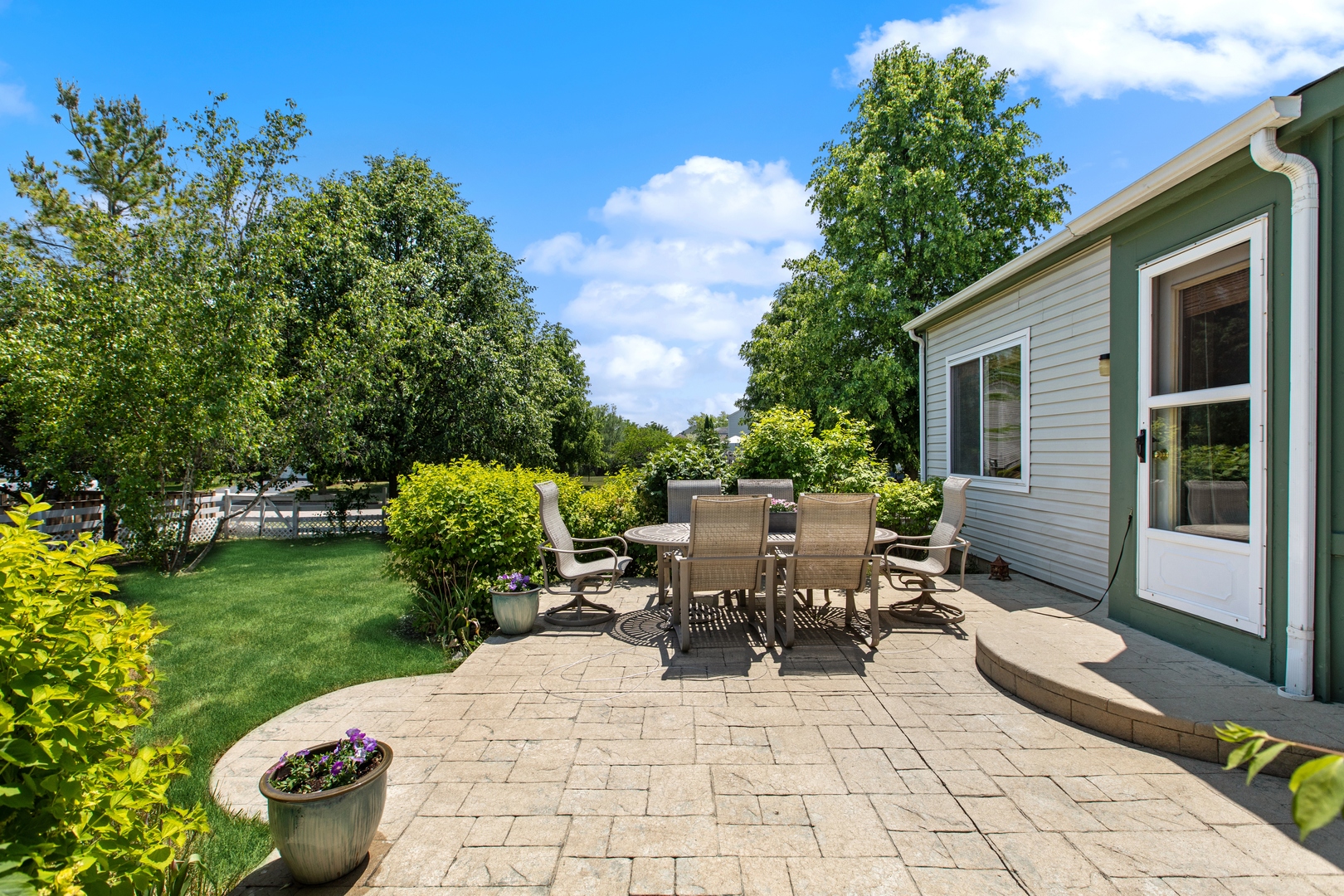 1039 Willow Bay Elgin, IL 60123 - Photo 24 of 30 a view of a patio with table and chairs potted plants with sky view