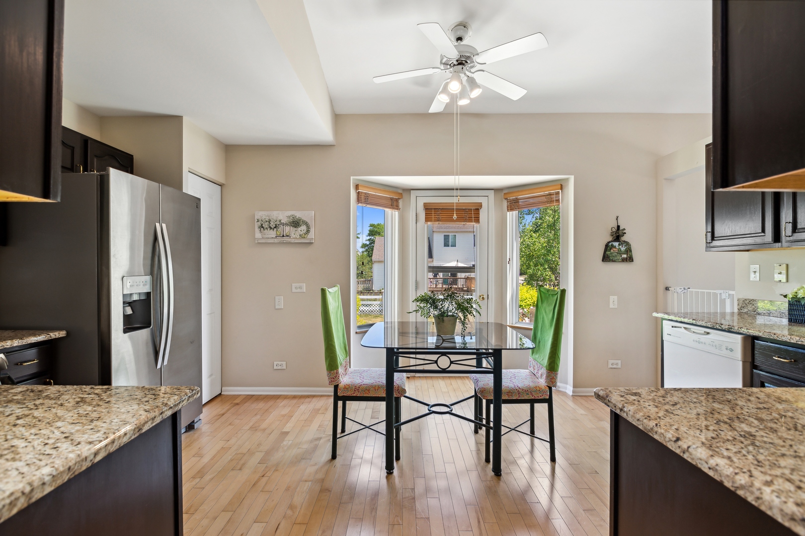 1039 Willow Bay Elgin, IL 60123 - Photo 10 of 30 a kitchen with granite countertop center island wooden floor and stainless steel appliances