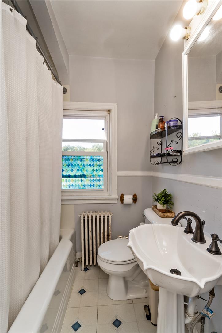 331 East Lizard Creek Road Lehighton, PA 18235 - Photo 33 of 37 A well-lit lavatory features a distinctive pedestal sink, tub with shower, and tiled flooring.