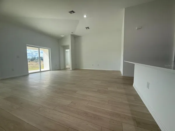 a view of an empty room with glass door