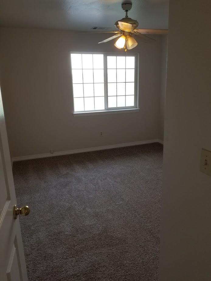 23135 Kindlespire Road Proberta, CA 96078 - Photo 11 of 33 an empty room with a window and a chandelier fan
