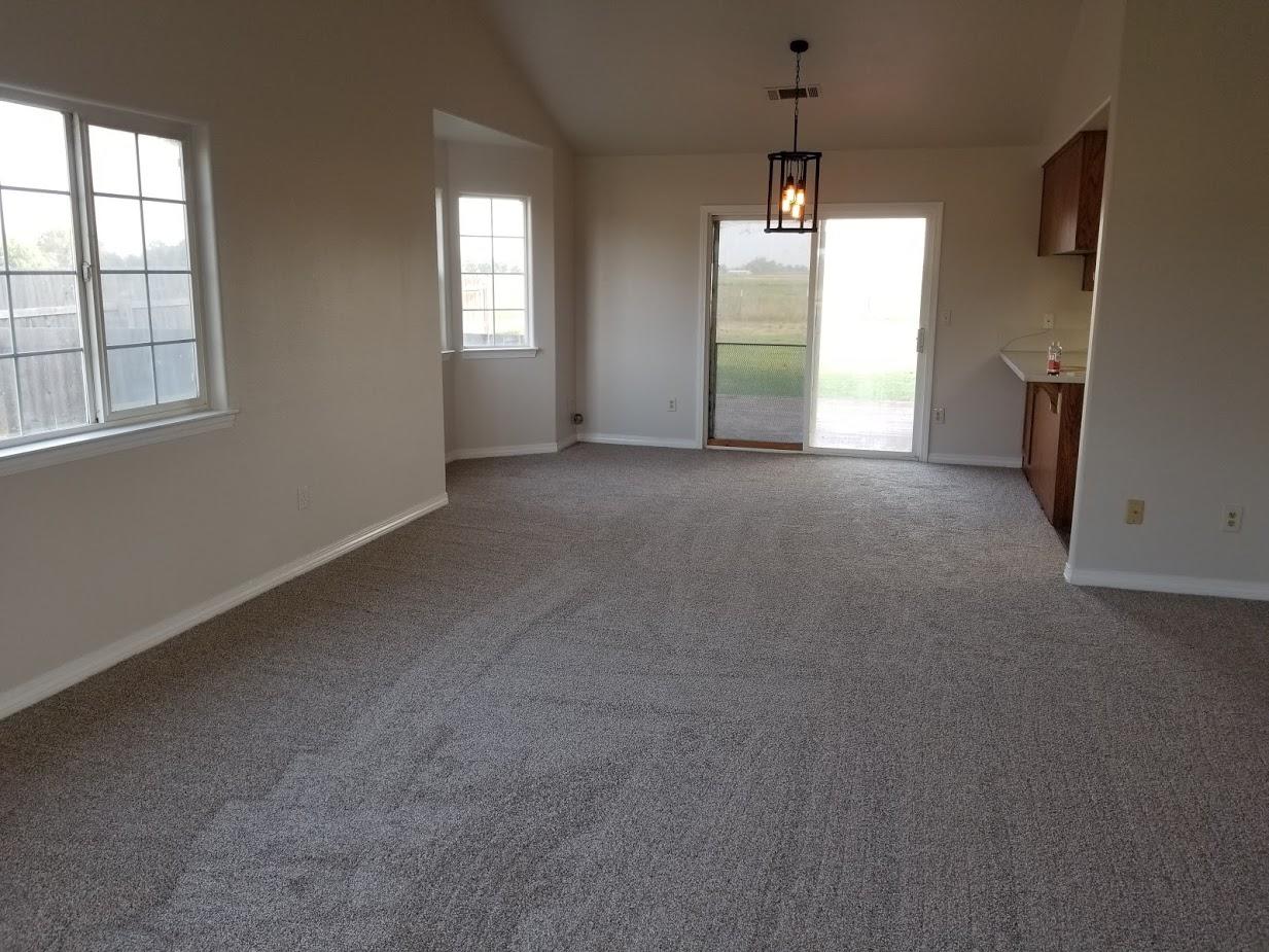 23135 Kindlespire Road Proberta, CA 96078 - Photo 6 of 33 an empty room with windows and chandelier