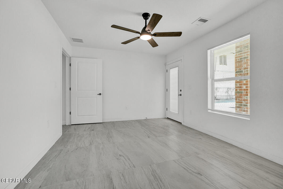 1107 Myrtle Avenue, Unit AD El Paso, TX 79901 - Photo 14 of 33 a view of an empty room with wooden floor and a window