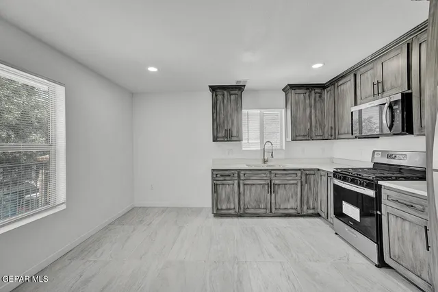 a kitchen with a sink cabinets and window