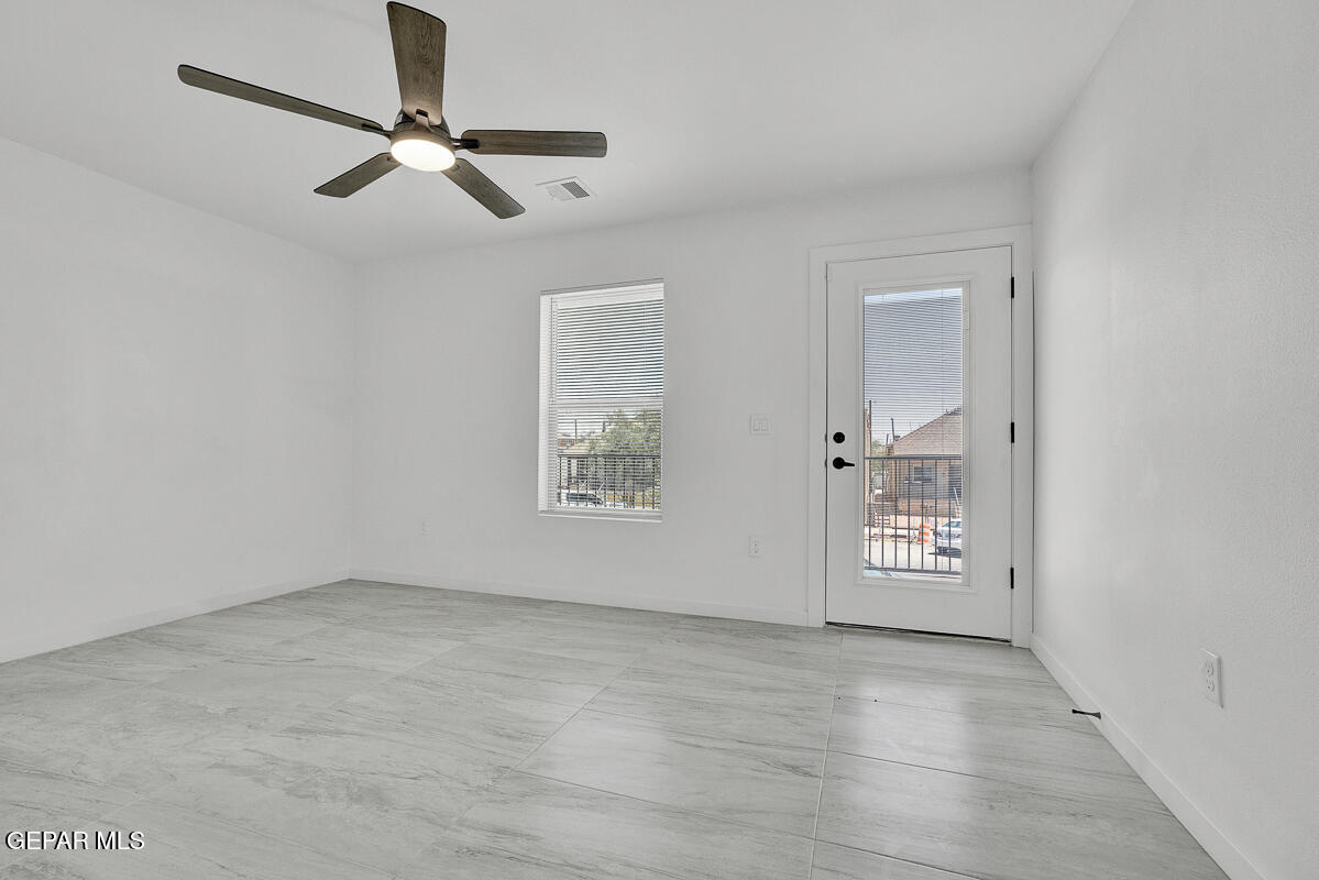1107 Myrtle Avenue, Unit AD El Paso, TX 79901 - Photo 28 of 33 an empty room with windows and fan