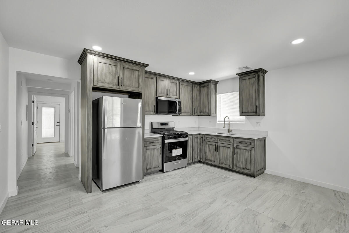 1107 Myrtle Avenue, Unit AD El Paso, TX 79901 - Photo 7 of 33 a kitchen with stainless steel appliances granite countertop a refrigerator stove a sink and dishwasher