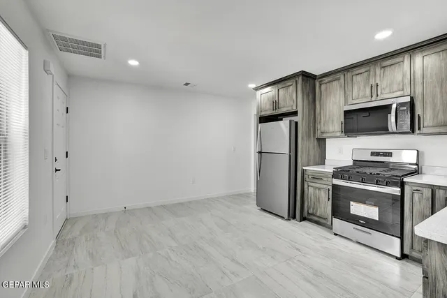 a kitchen with refrigerator cabinets and stainless steel appliances