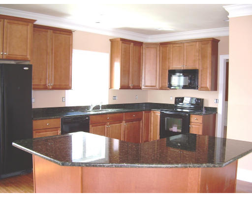 5 Brookview Road, Unit 5 Windham, NH 03087 - Photo 2 of 2 a kitchen with kitchen island granite countertop a sink stove and granite counter top