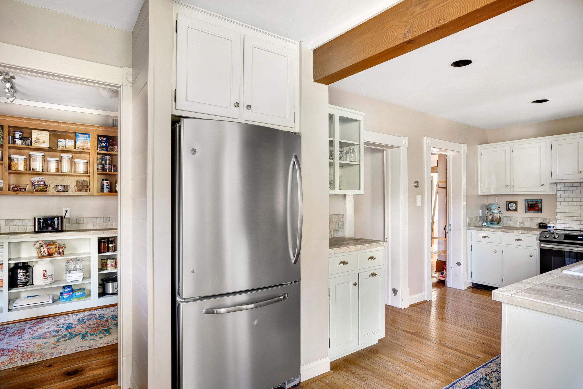 5979 Back Road Woodstock, VA 22664 - Photo 12 of 49 a kitchen with stainless steel appliances a refrigerator a sink a stove and white cabinets