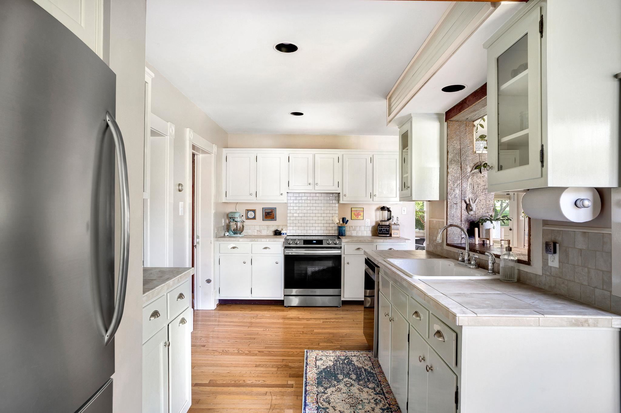 5979 Back Road Woodstock, VA 22664 - Photo 10 of 49 a kitchen with a sink stove and refrigerator