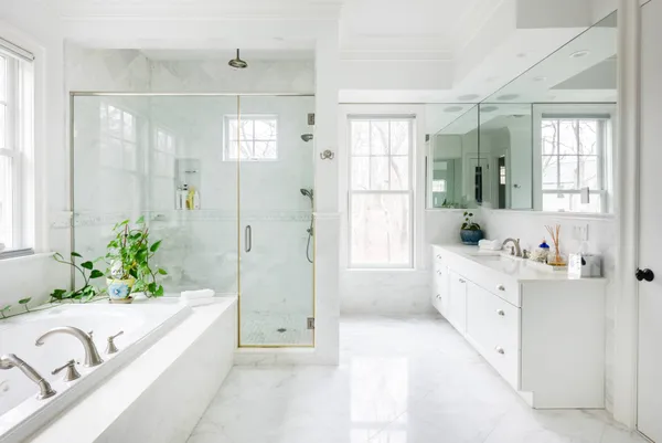 a spacious bathroom with a bathtub and shower