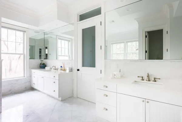 a bathroom with a sink vanity and mirror