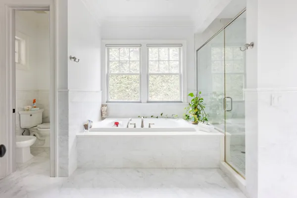 a bath tub sitting next to a white sink