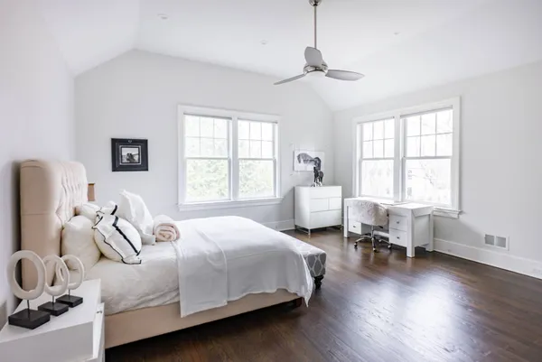 a bedroom with bed couch and window