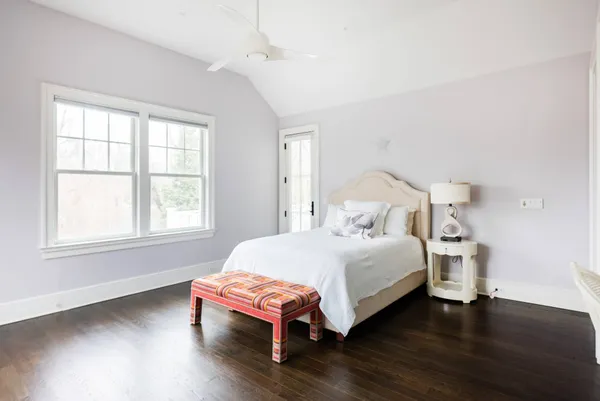 a bedroom with a bed table and window