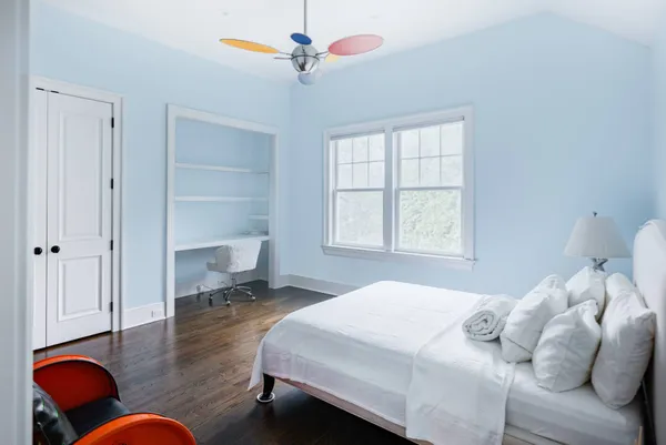 a bedroom with a bed and a chandelier