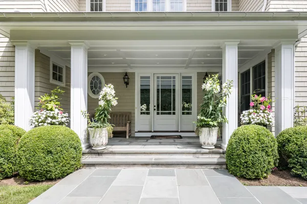 a view of a house with potted plants