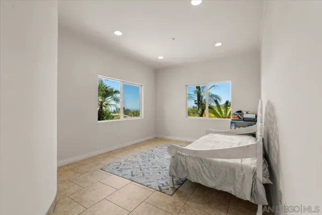 a bedroom with a bed and painting on the wall