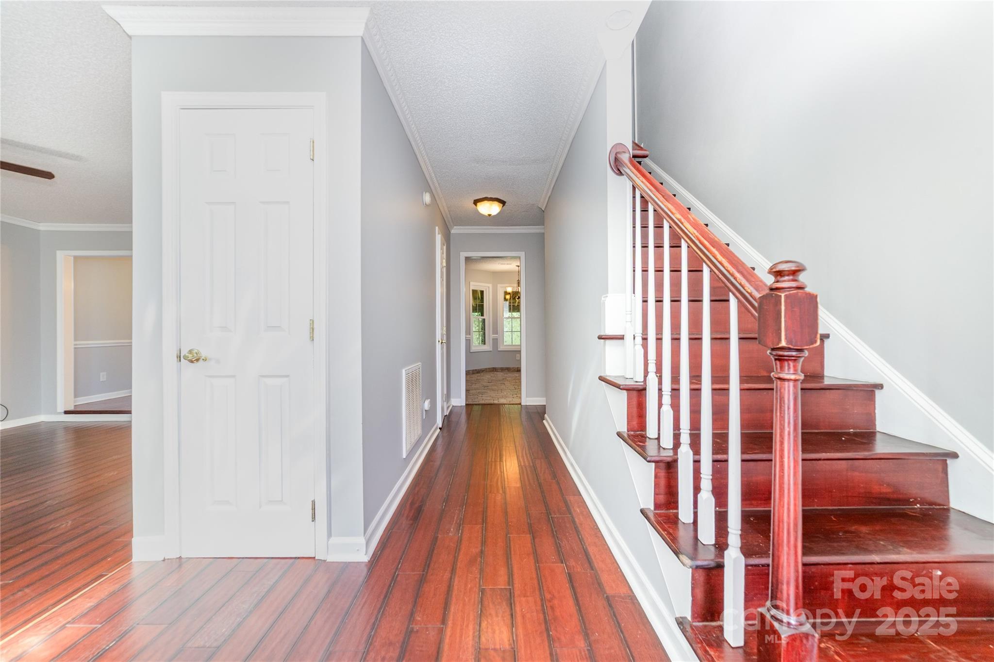 200 Sidney Court Monroe, NC 28110 - Photo 2 of 18 a view of a hallway with wooden floor and staircase