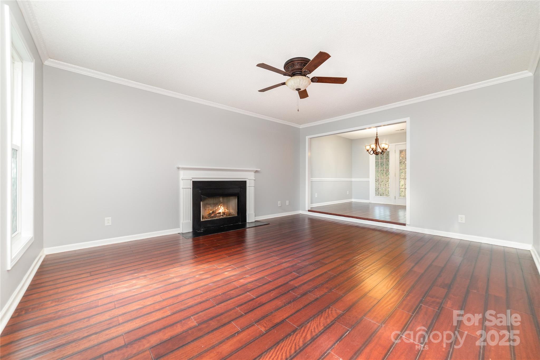 200 Sidney Court Monroe, NC 28110 - Photo 3 of 18 a view of empty room with wooden floor and fireplace