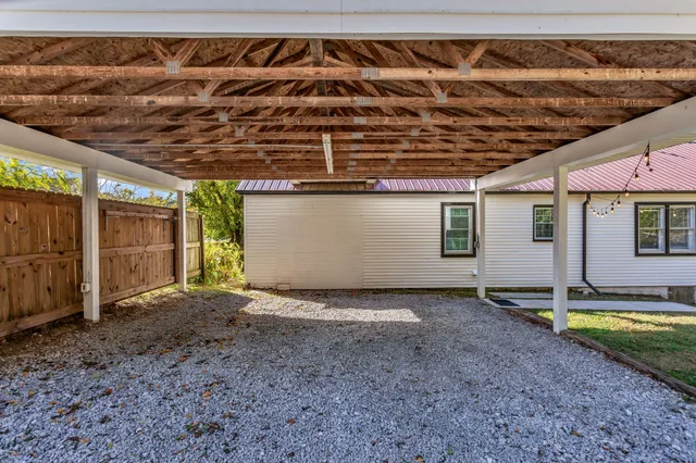 a view of a backyard with wooden fence