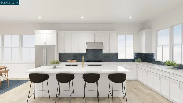 a kitchen with a dining table chairs and white appliances