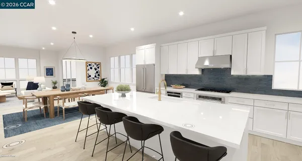 a kitchen with stainless steel appliances kitchen island granite countertop a table chairs sink and white cabinets