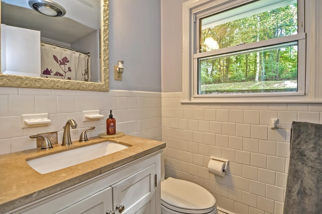 161 Salem Road Billerica, MA 01821 - Photo 14 of 30 a bathroom with a granite countertop toilet sink and mirror