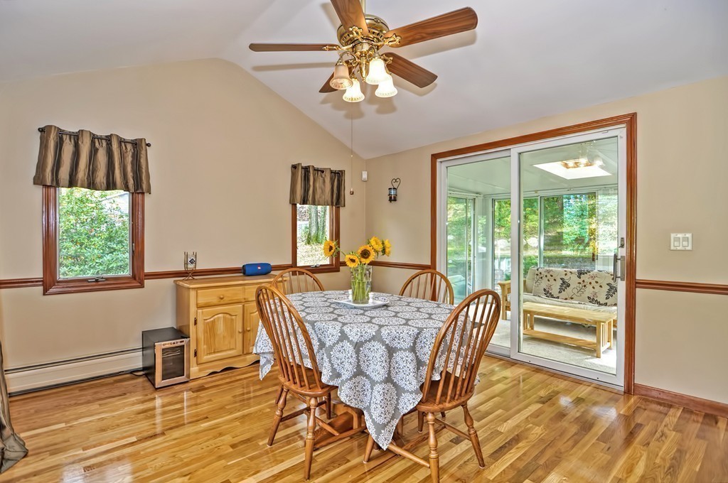 161 Salem Road Billerica, MA 01821 - Photo 8 of 30 a dining room with wooden floor a chandelier a glass table and chairs