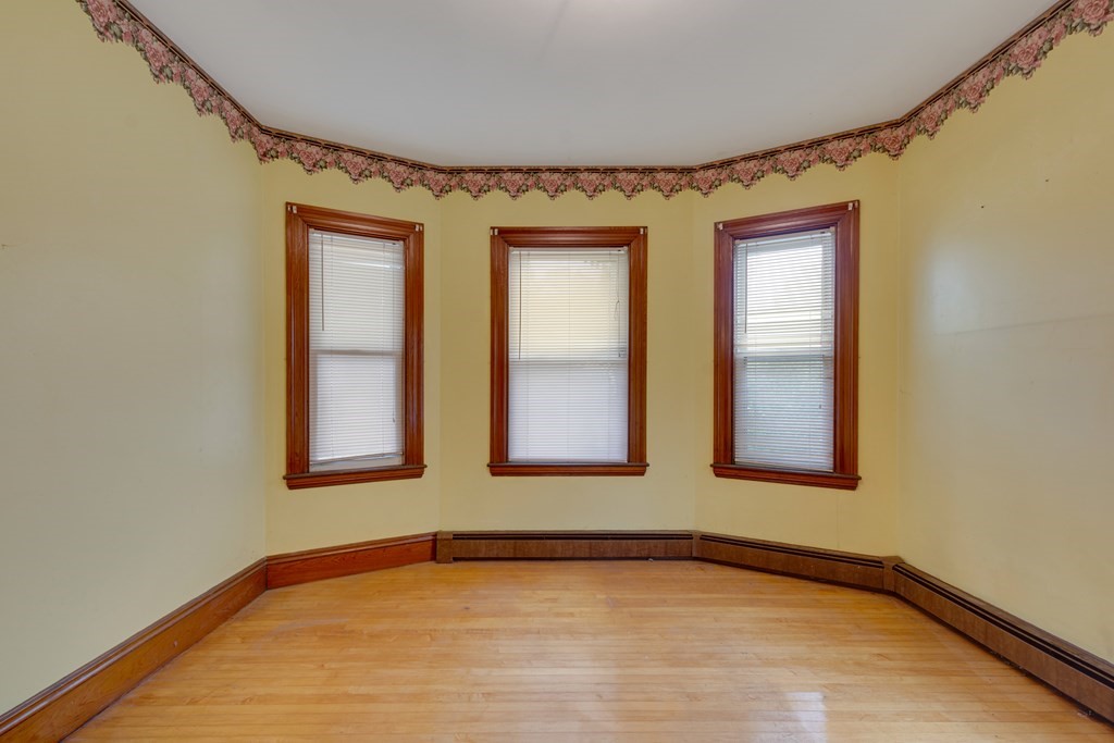 33 Oak Street Boston, MA 02136 - Photo 14 of 18 a view of an empty room with window and wooden floor