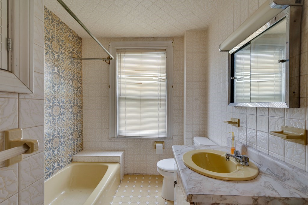 33 Oak Street Boston, MA 02136 - Photo 17 of 18 a bathroom with a sink a bathtub and a window