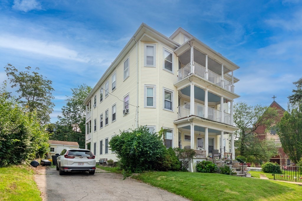 33 Oak Street Boston, MA 02136 - Photo 2 of 18 a front view of a house with a garden